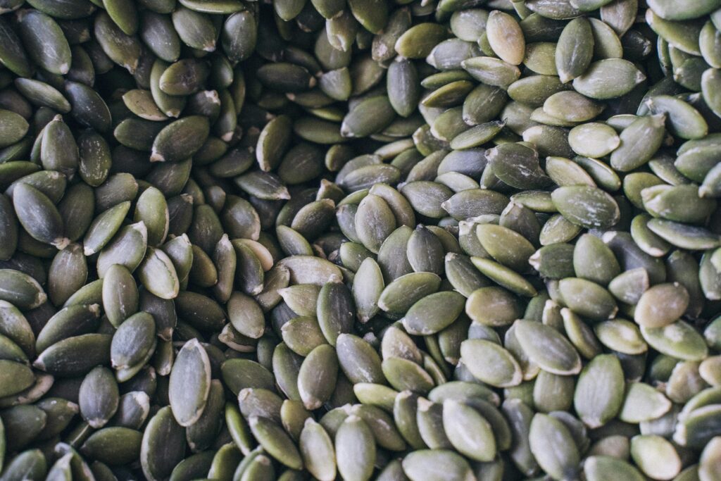 A close-up shot of organic pumpkin seeds showcasing their natural texture and green hue.
